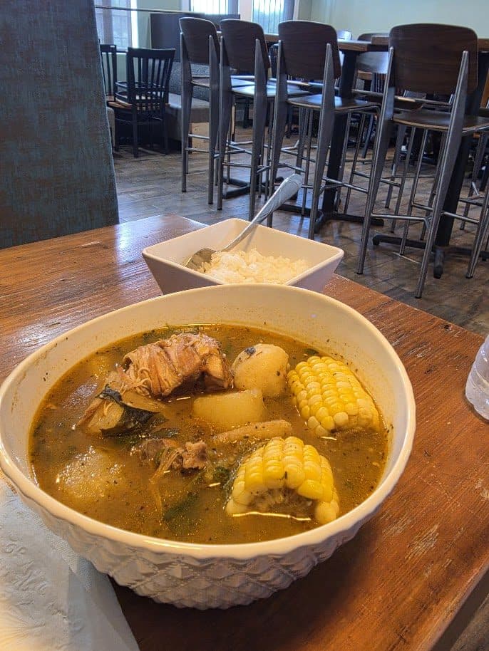 Hearty sancocho with corn on the cob